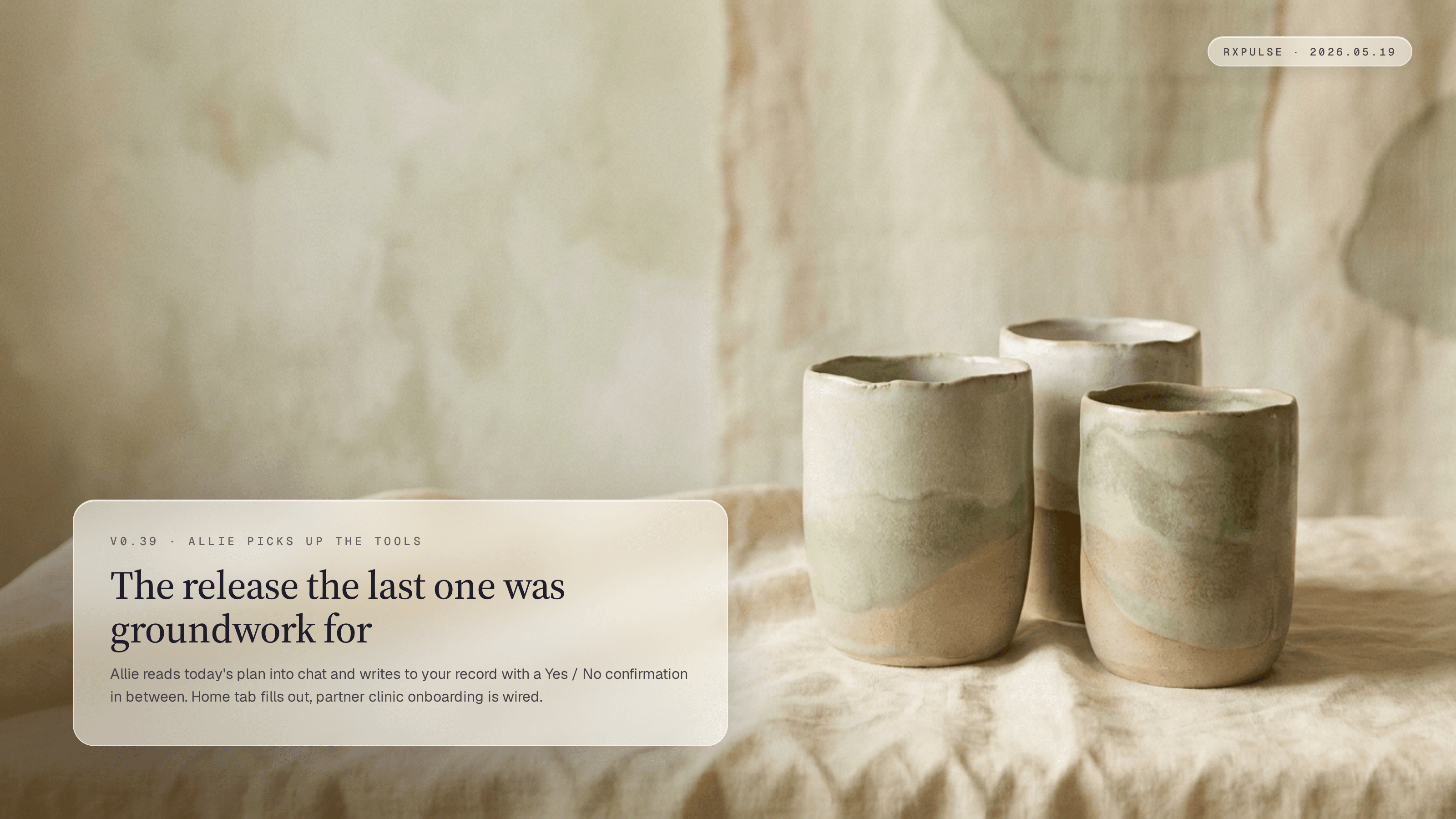 Editorial launch artwork. Two or three soft hand-poured ceramic vessels of slightly different heights resting on a warm linen surface, paired with a glass caption card naming the release where allie picks up the tools.