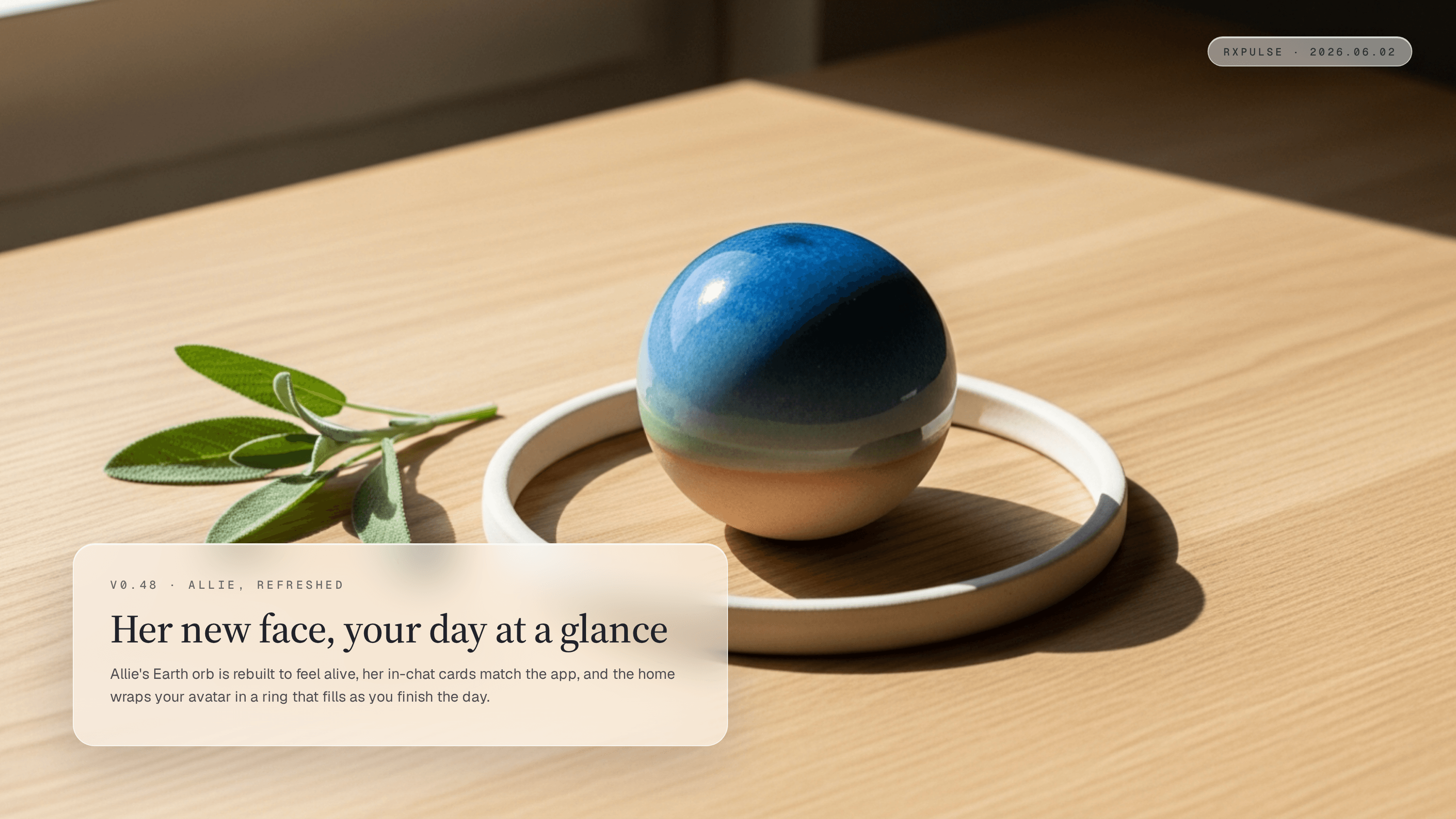 Editorial still life on pale oak in soft warm window light. A glowing teal glazed ceramic sphere, lit like a small planet seen from orbit, rests inside a thin open ceramic ring laid flat on the warm oak so the ring frames it like a measure being filled. A sprig of fresh sage rests to the side. A glassmorphism caption card in the lower-left carries the eyebrow "v0.48 · A WARMER RXPULSE" with the headline "A new look, and an app that grows with you." and a short summary, and a monospace RxPulse brand pill sits in the top-right.