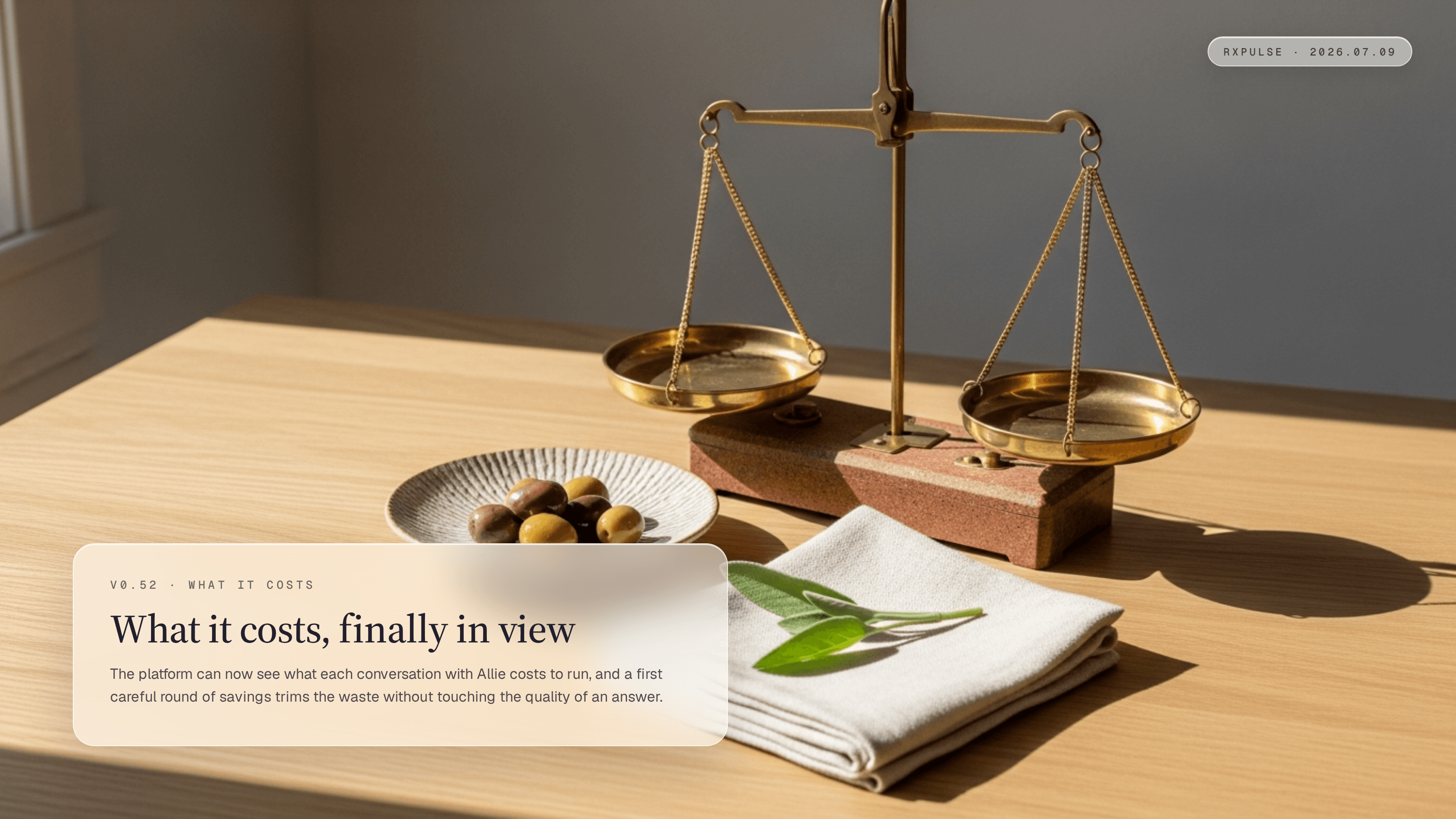 A still life of brass balance scales beside a small dish of olives and folded linen in warm window light, the measurement metaphor for this release.