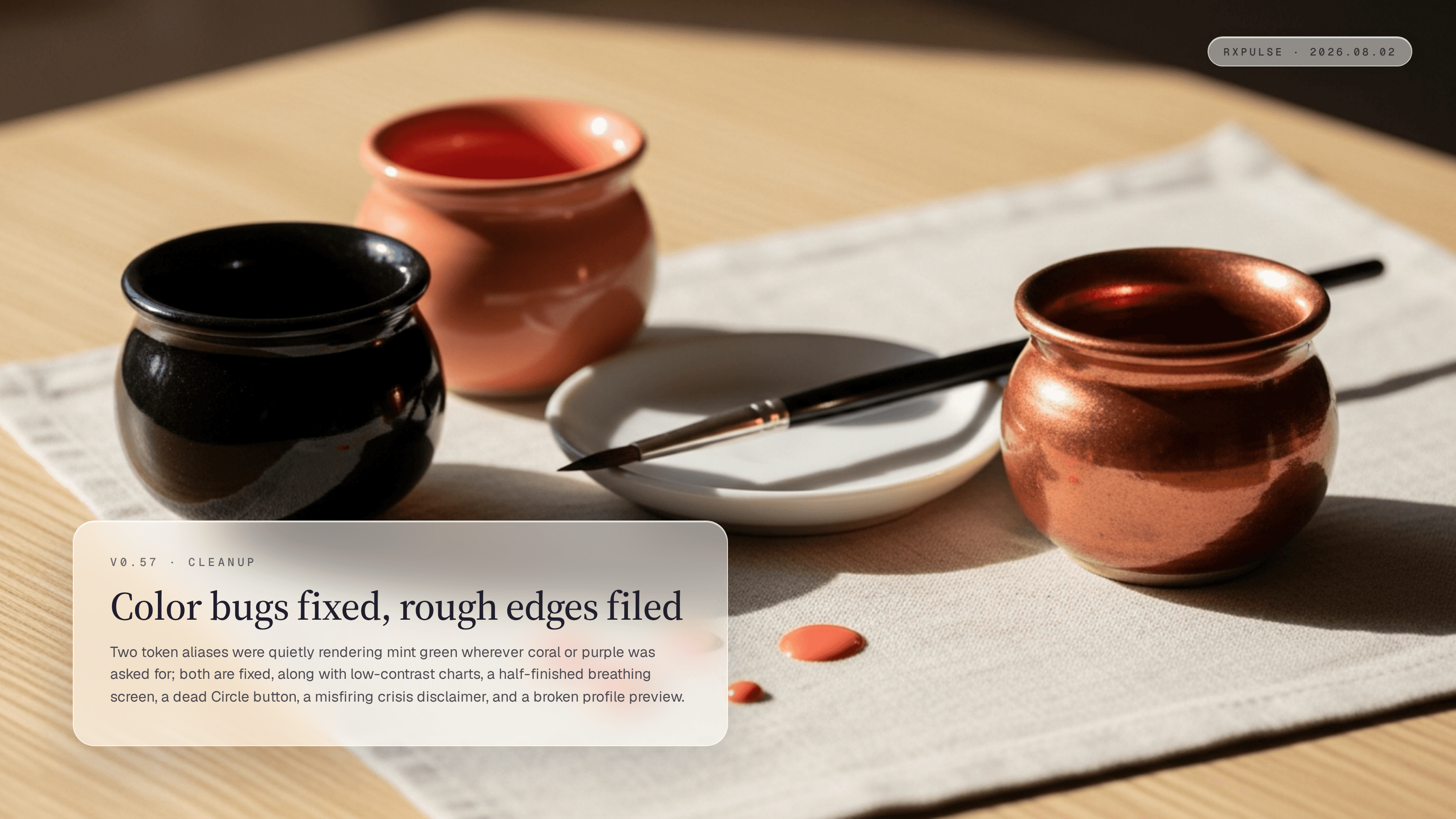 Release hero art: three small ceramic pots of pigment in ink black, warm coral, and burnished copper beside a brush and porcelain dish on warm linen, captioned "Color bugs fixed, rough edges filed."