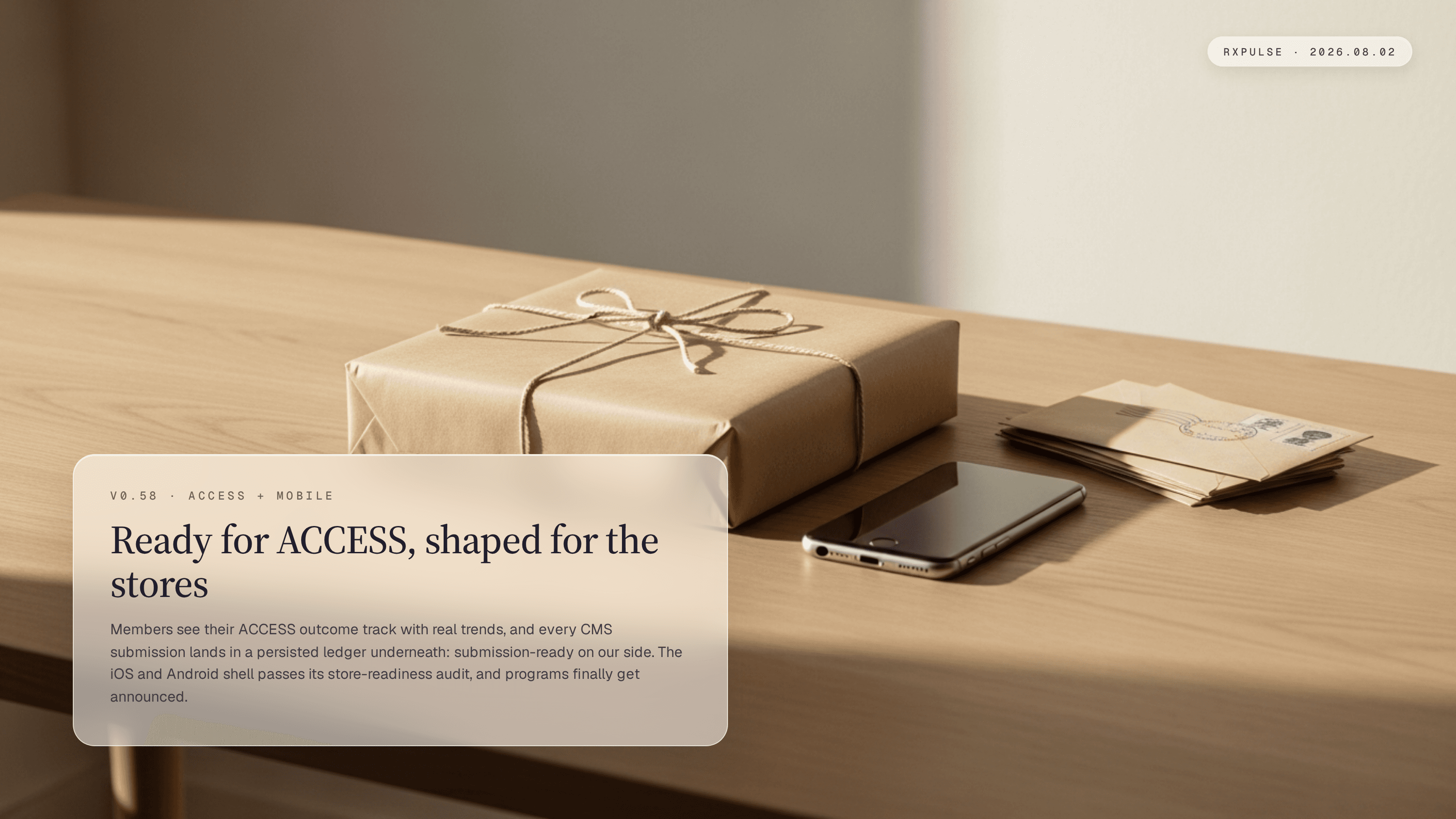Release hero art: a kraft paper parcel tied with twine ready to send, a phone lying face down, and stamped envelopes on a pale oak desk, captioned "Ready for ACCESS, shaped for the stores."